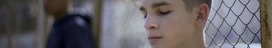 A young boy looking pensive