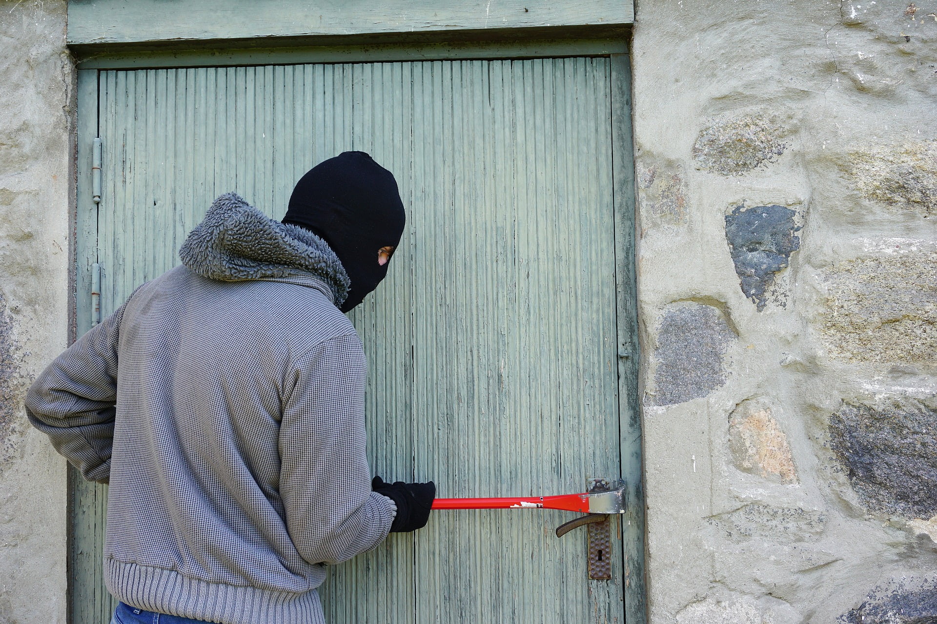 thief trying to break open a door